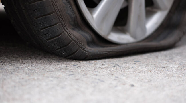 Car,Tire,Leak,Because,Of,Nail,Pounding.,Flat,Tyre,On